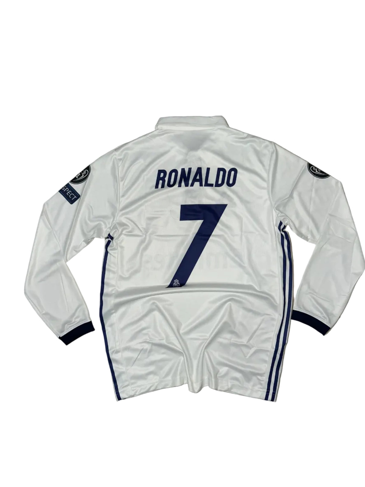 A white long-sleeve soccer jersey laid flat on a beige tiled floor, with navy blue trim, the number 7 on the back, and 'RONALDO' printed vertically. A Champions League patch is visible on the sleeve.